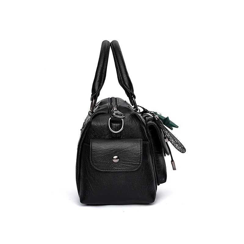Vintage women handbag in black soft leather with star pendant and top handles for stylish everyday use.