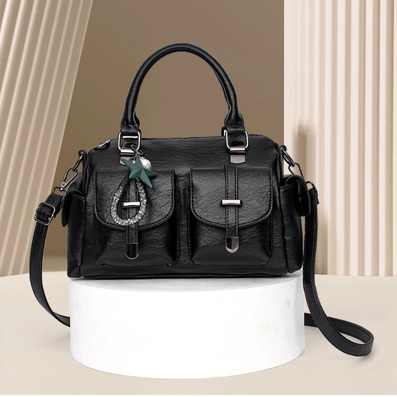 Vintage women's black leather handbag with star pendant and multi-pocket design, perfect for stylish accessorizing.