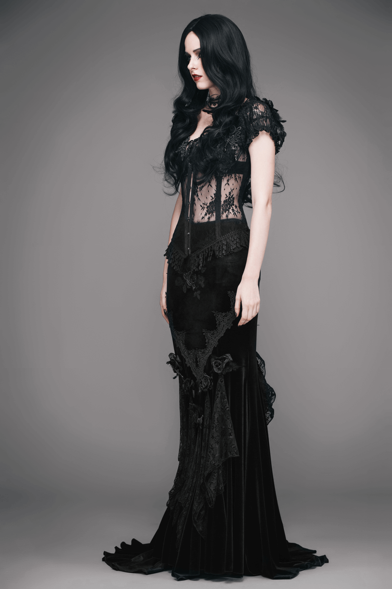Elegant woman in a vintage black gothic skirt with lace and embroidery, showcasing a stunning long design.