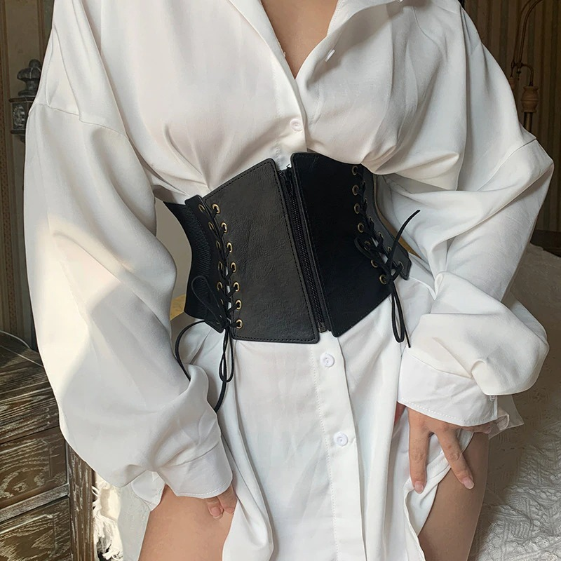 Elegant vintage women's gothic wide belt with lace-up and zipper details paired with a chic white shirt.