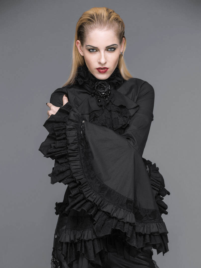 Model wearing a gothic black vintage blouse with long bell sleeves and ruffles, showcasing a stand-up collar.