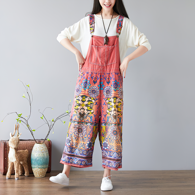 Vintage women's wide-leg floral print jumpsuit in orange with colorful patterns, perfect for stylish, unique outfits.