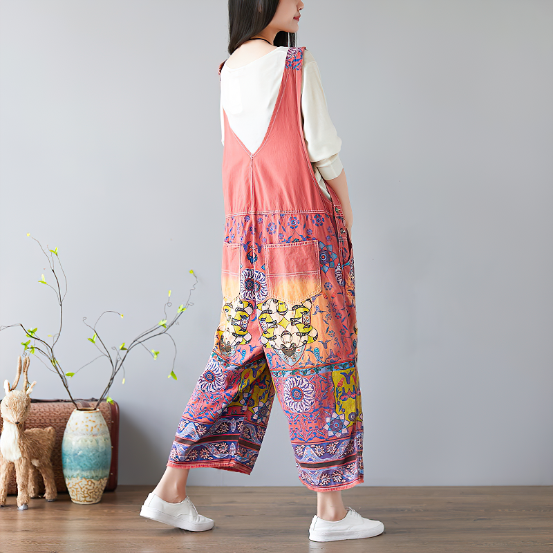 Fashionable vintage women's wide-leg jumpsuit with floral print in vibrant colors, perfect for a stylish hippie look.
