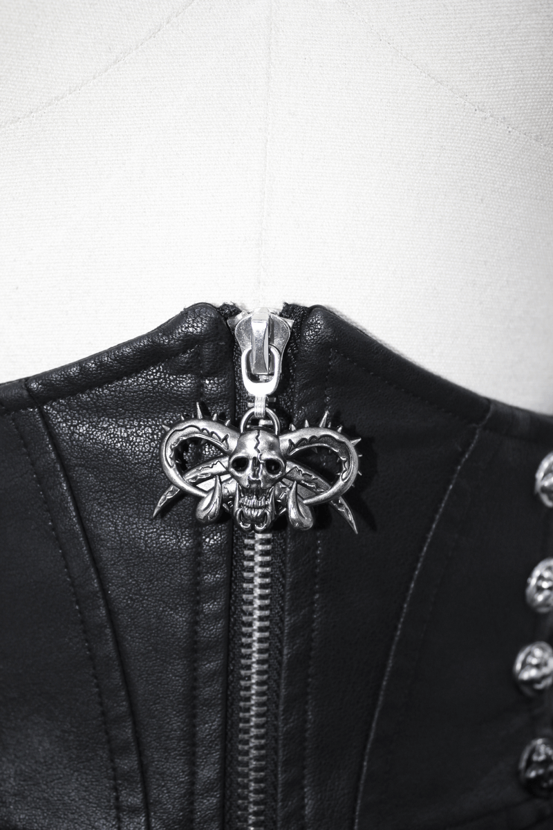 Close-up of a black leather corset with a skull zipper and studded details, highlighting punk fashion elements.