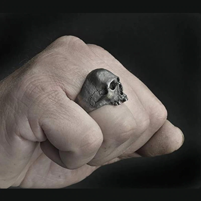 Vintage silver skull ring on a hand, perfect for edgy rock and biker styles, made from zinc alloy.