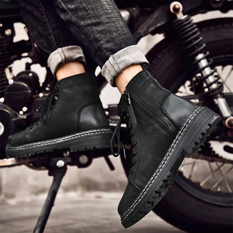 Warm men's black leather ankle boots with laces, styled with casual jeans, perfect for everyday wear.