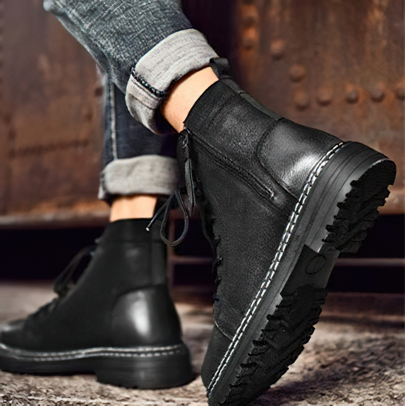 Stylish men's black leather ankle boots with flexible soles for casual wear.