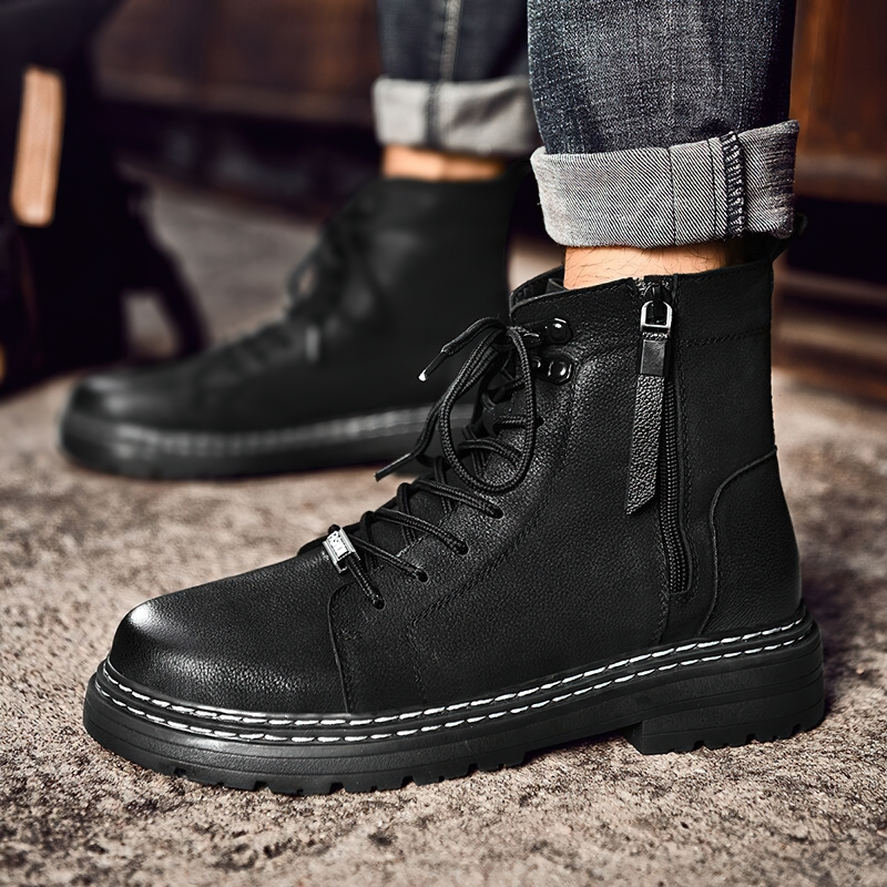 Stylish men's black leather ankle boots with laces and flexible soles for casual wear.