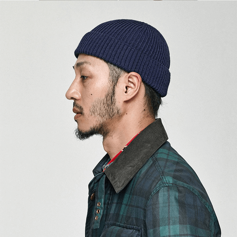 Casual men's wool skull beanie in navy, worn by model with plaid shirt, showcasing stylish warmth for men.