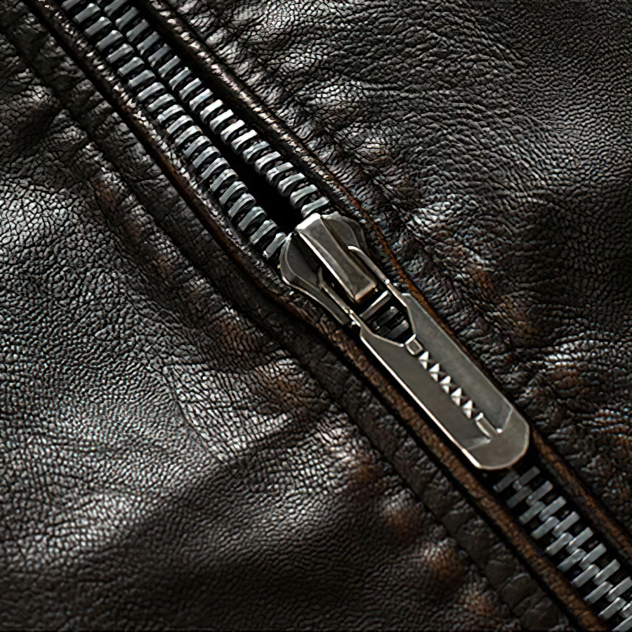 Close-up of a durable zipper on a warm PU leather motorcycle jacket for men.