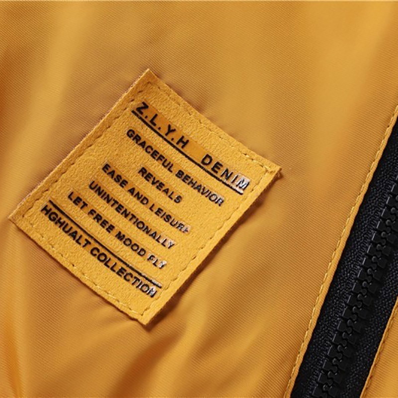 Close-up of a yellow fabric tag from ZLYH Denim; features text about ease, style, and collection details.
