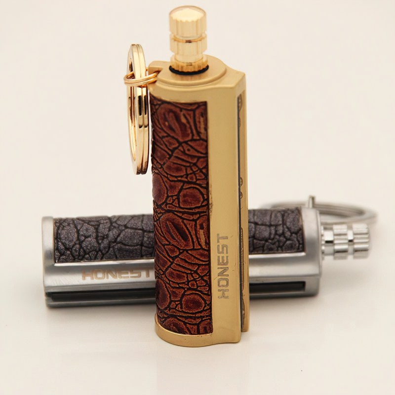 Stylish waterproof kerosene lighter keychain in gold and silver vintage design, perfect for outdoor adventures.