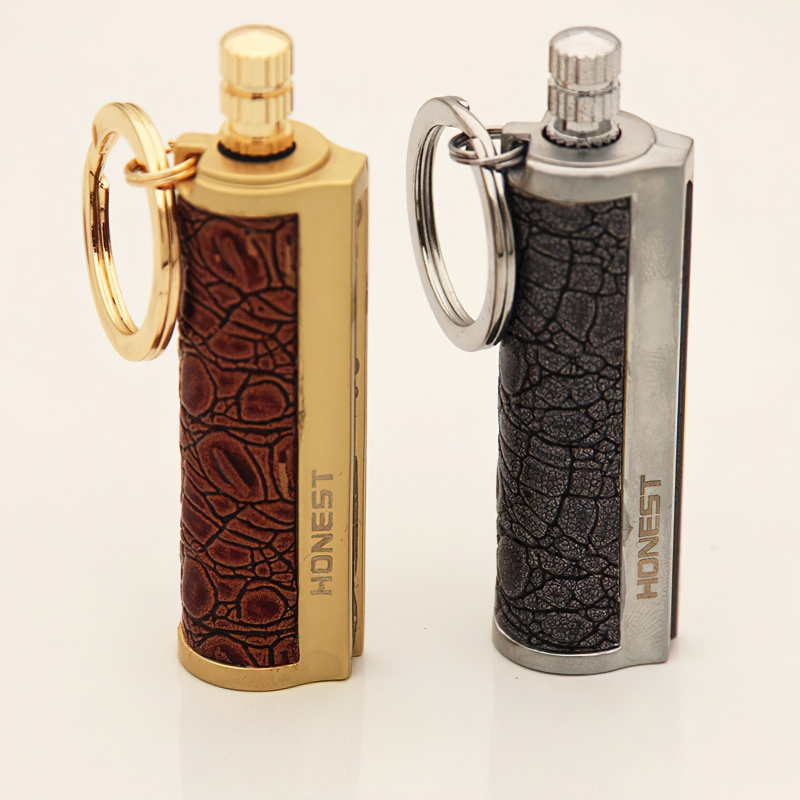 Two vintage-style waterproof metal kerosene lighters on a keychain in gold and silver colors.