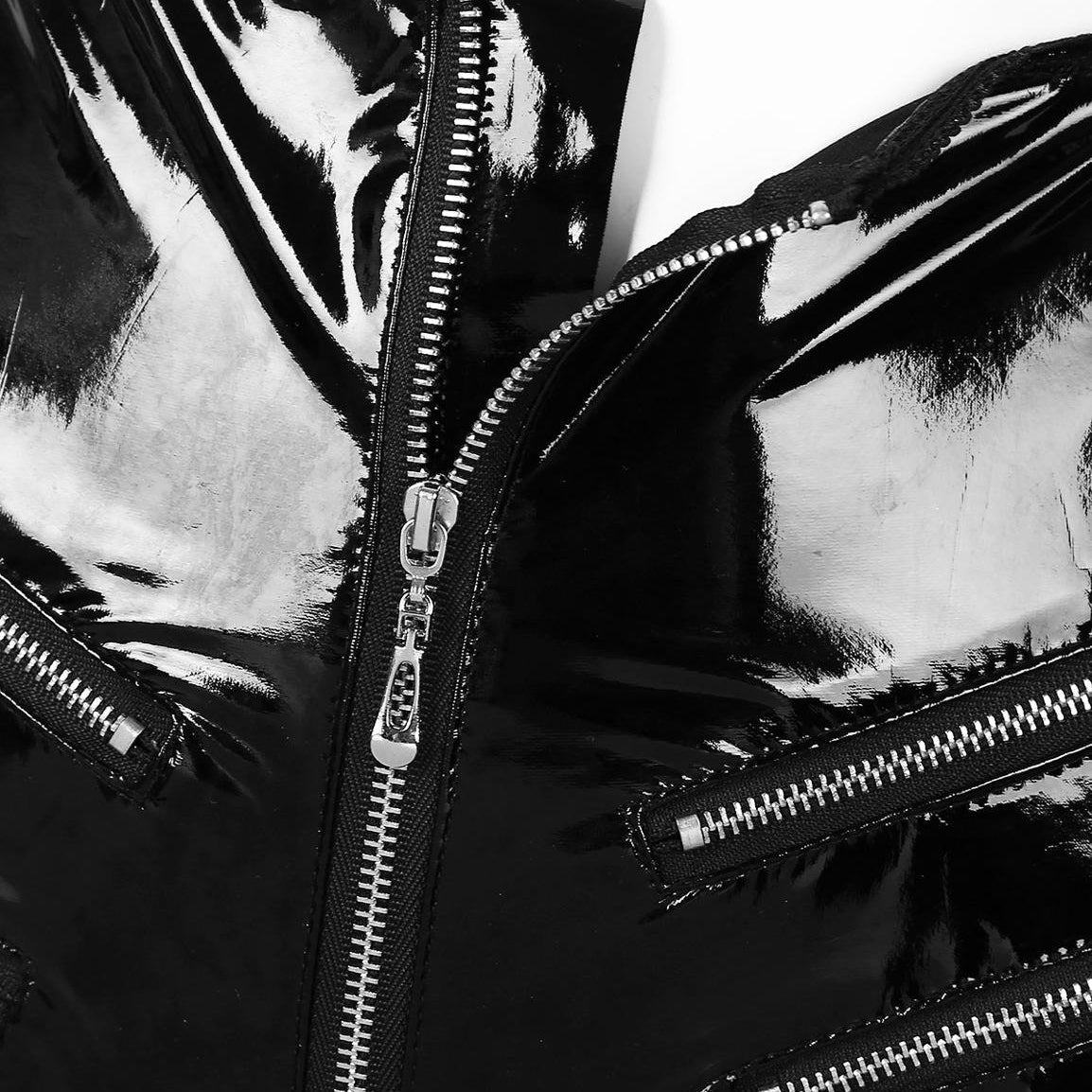 Close-up of shiny black latex shorts featuring zip details, highlighting a sexy rock chick style.