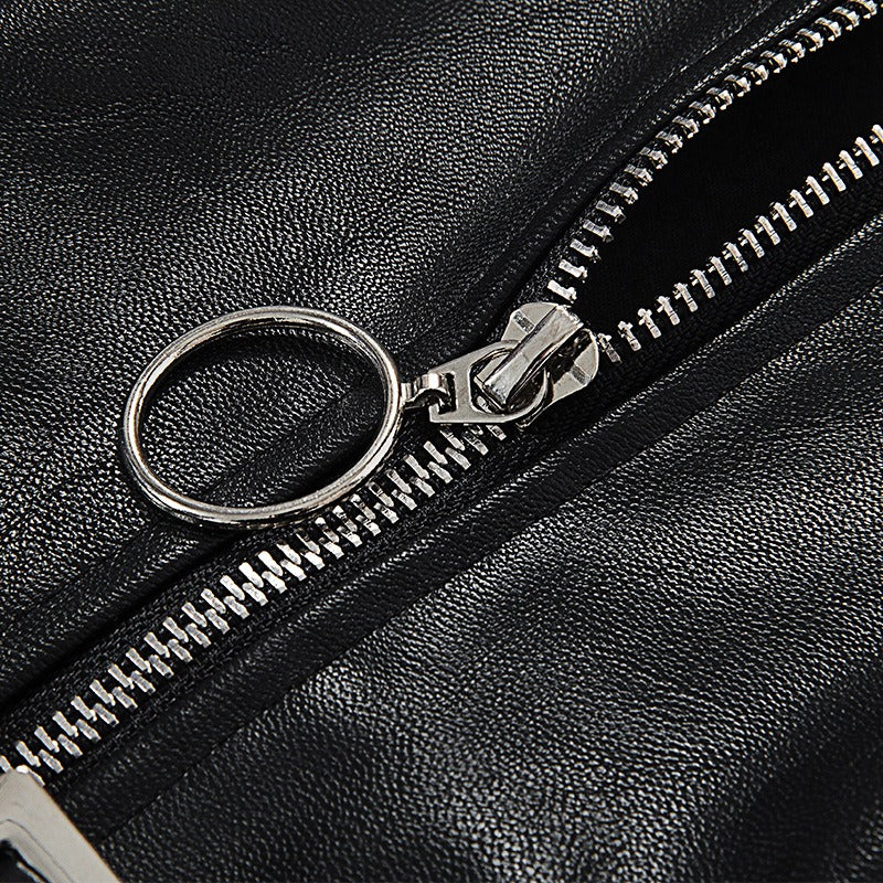 Close-up of a silver zipper on a black leather garment, showcasing its stylish Gothic design.