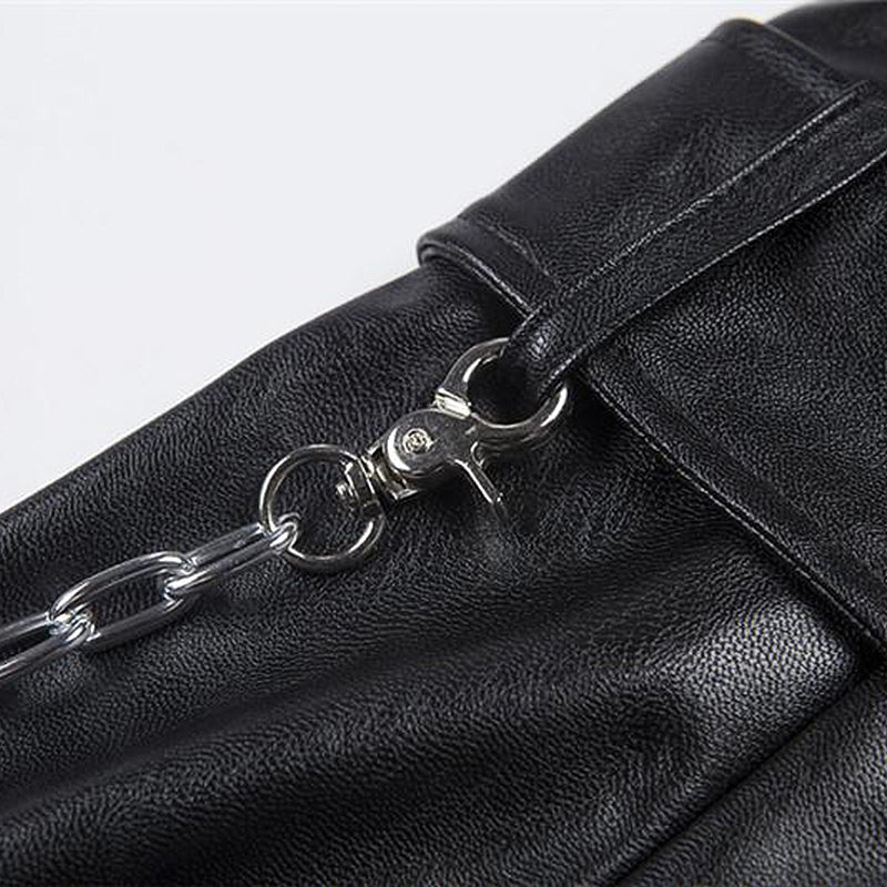 Close-up of a black bag featuring a silver chain and latch for a trendy Gothic look.
