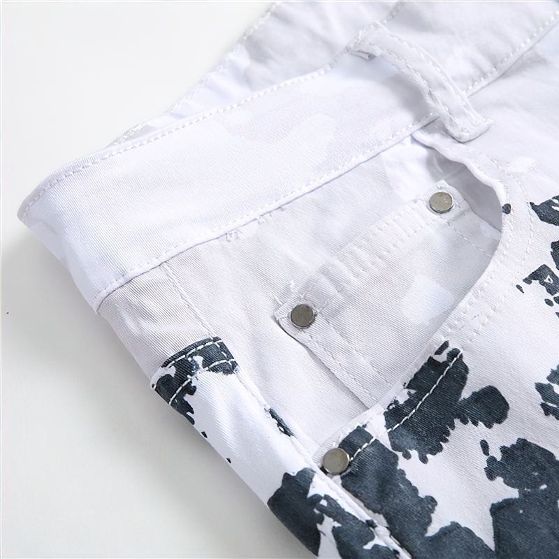 Close-up of white jeans with blue camo print, showcasing zipper fly and stylish design for rock enthusiasts.