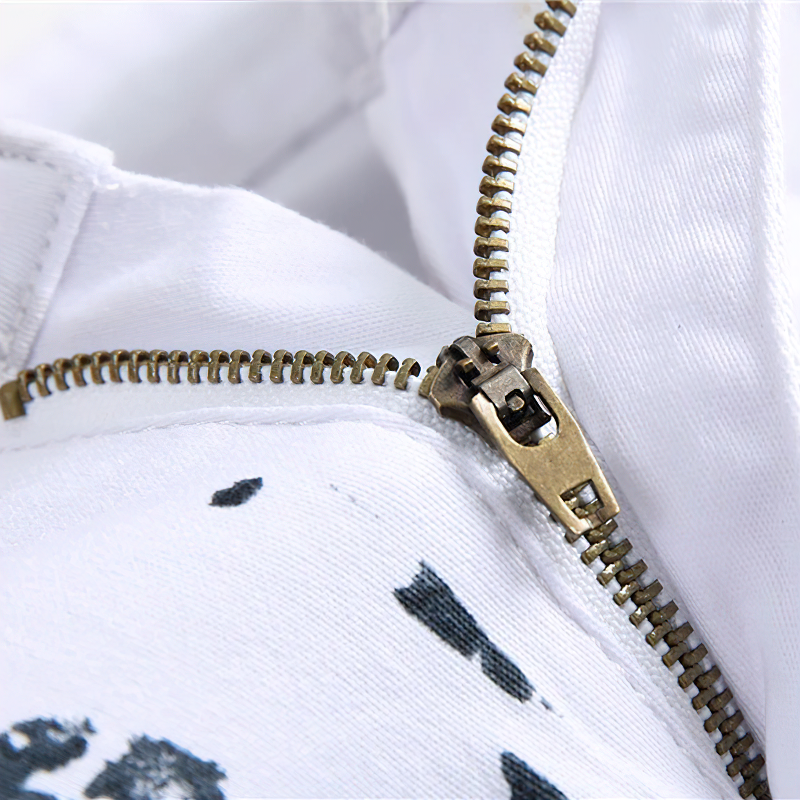 Close-up of a zipper on white jeans pants featuring a USA flag print, showcasing stylish rock fashion details.