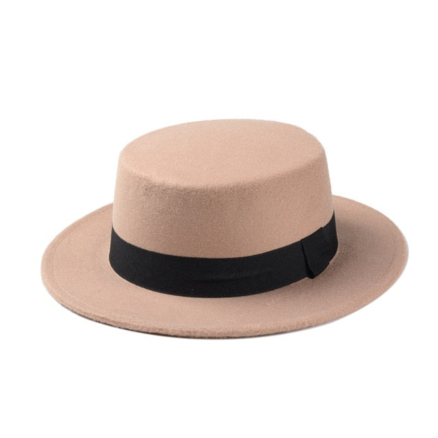 Stylish wide brim gambler hat in beige with a black ribbon, perfect for individual and memorable fashion statements.