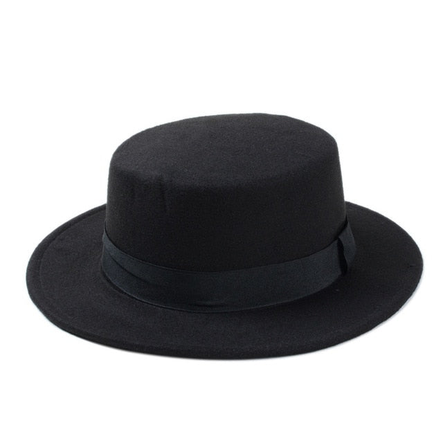 Wide brim black gambler hat with flat top and ribbon band, perfect for women's alternative fashion and cooler seasons.