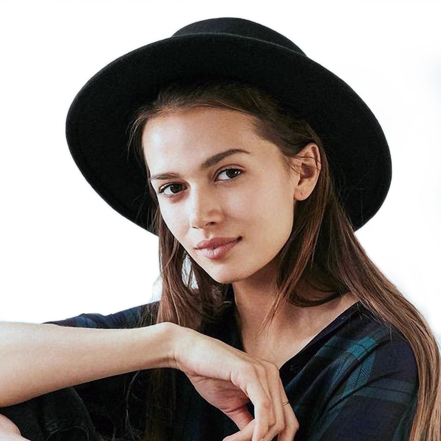 Woman wearing a wide brim Gambler hat, showcasing stylish flat-top Fedora for alternative fashion.