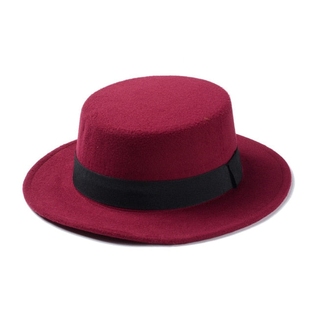 Wide brim maroon flat-top fedora hat with black band, perfect for women’s alternative fashion.