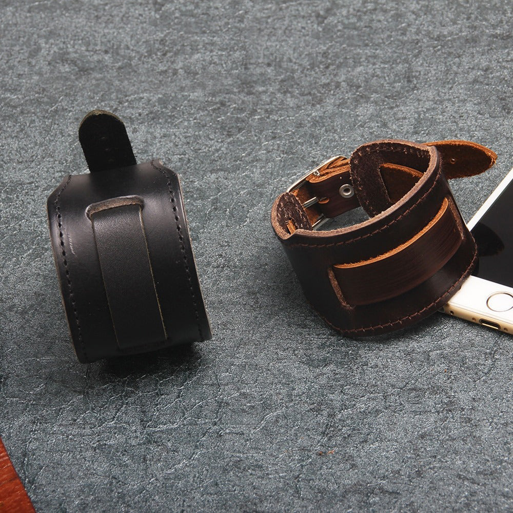 Wide genuine leather bracelets in black and brown, showcasing vintage rock style for unisex biker jewelry.