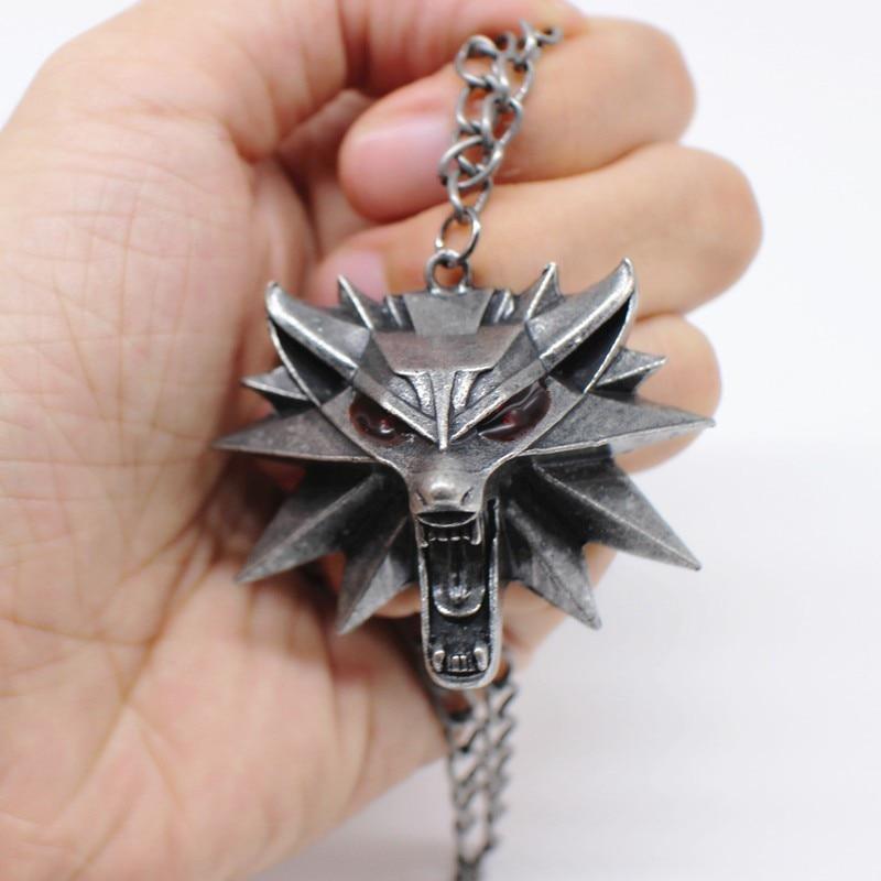 Wild Hunt Game Wolf Pendant Necklace held in hand, featuring a fierce wolf head and link chain design.