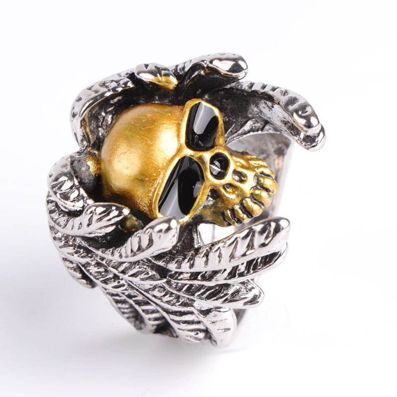 Winged skull ring with golden skull and silver foliage, perfect for steampunk and punk jewelry lovers.