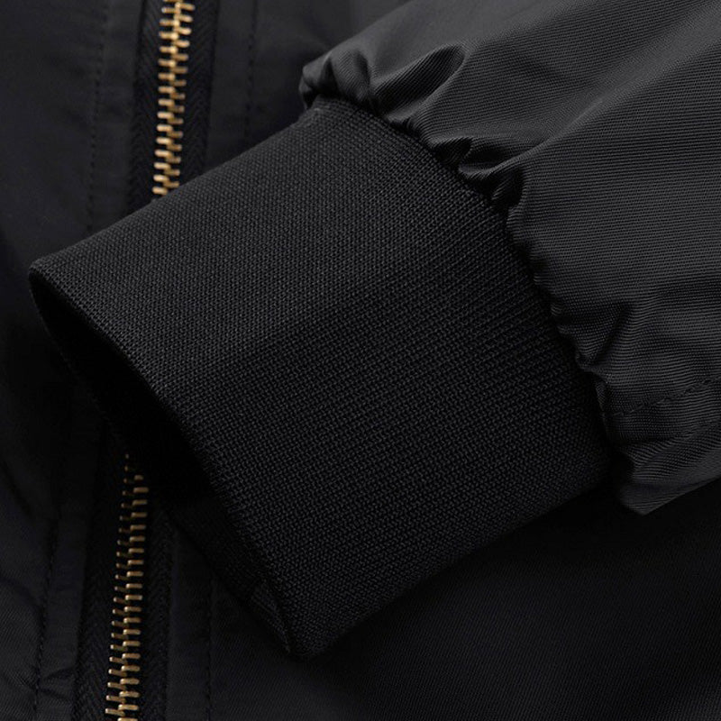Close-up of the cuff on a black cotton padded MA-1 bomber jacket, showcasing its stylish design and quality.