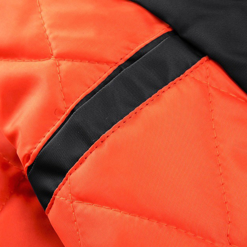 Close-up of the stylish orange and black cotton padded fabric of a men's pilot bomber jacket.