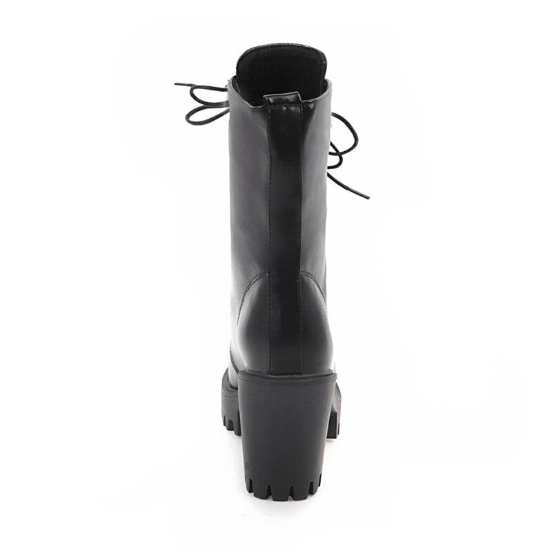 Back view of stylish black women's fashion boots with square heel and laces, showcasing gothic fashion details.