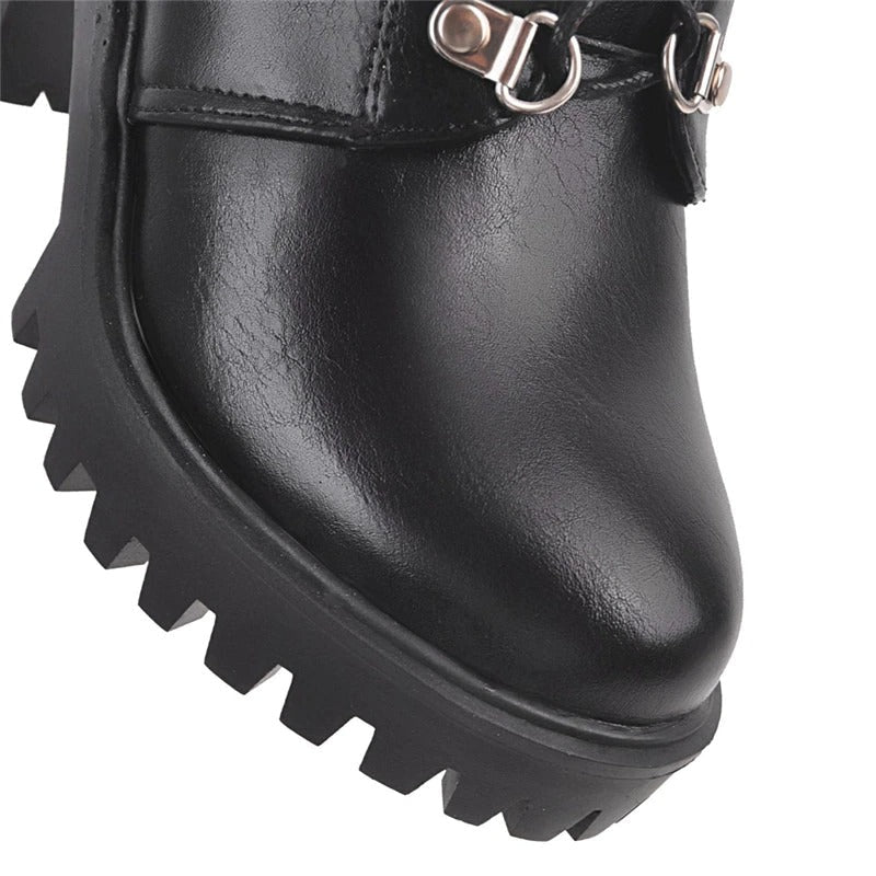 Close-up of black gothic fashion boot with chunky platform and stylish buckle details.