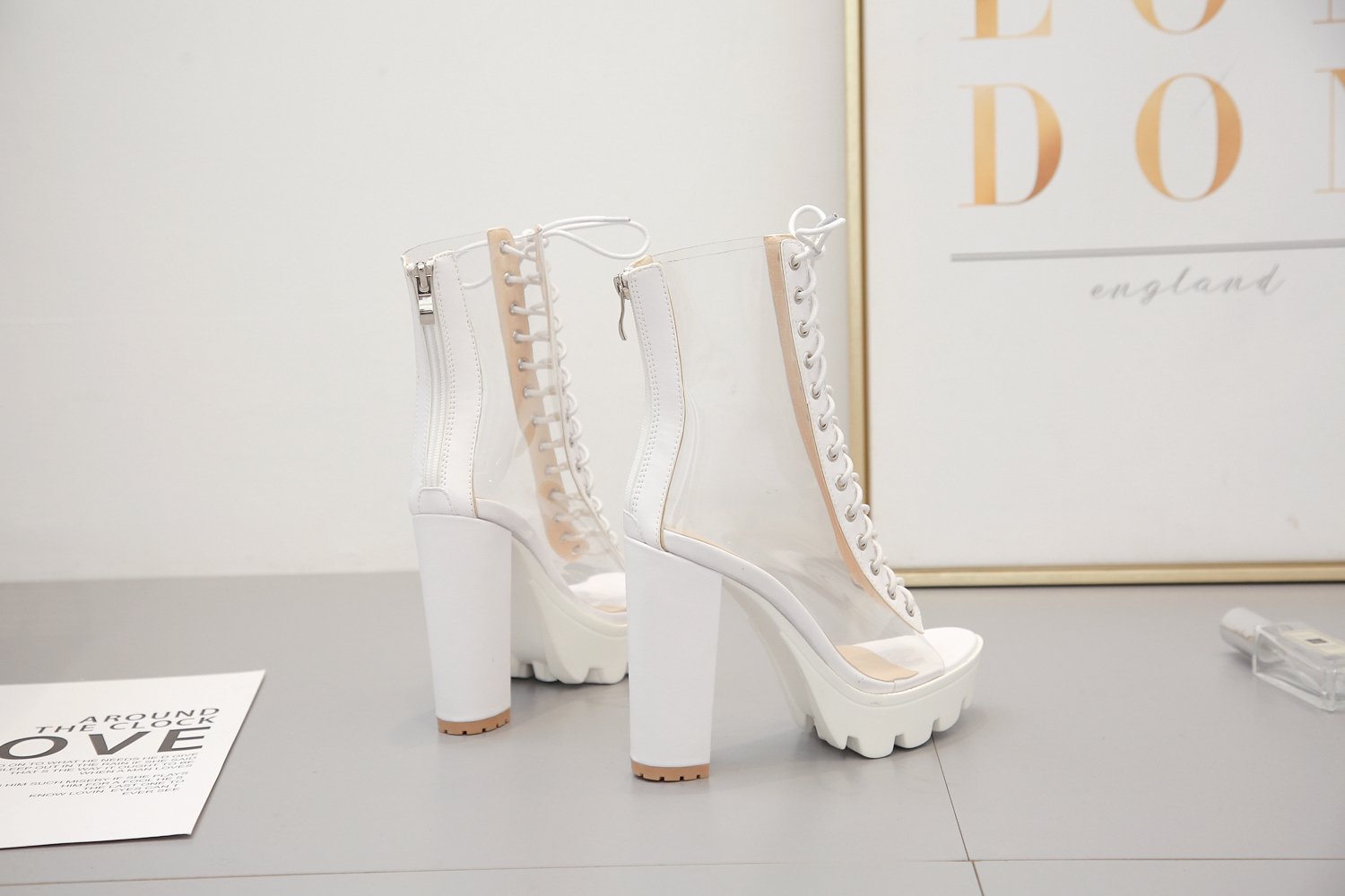 Stylish women ankle transparent shoes with peep toe, zip back, and chunky white platform heels.