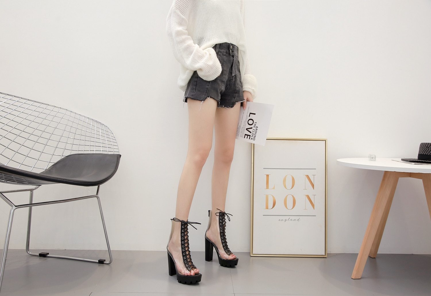 Women wearing ankle transparent pumps with peep toe and lace-up detail, styled with shorts and a cozy sweater.