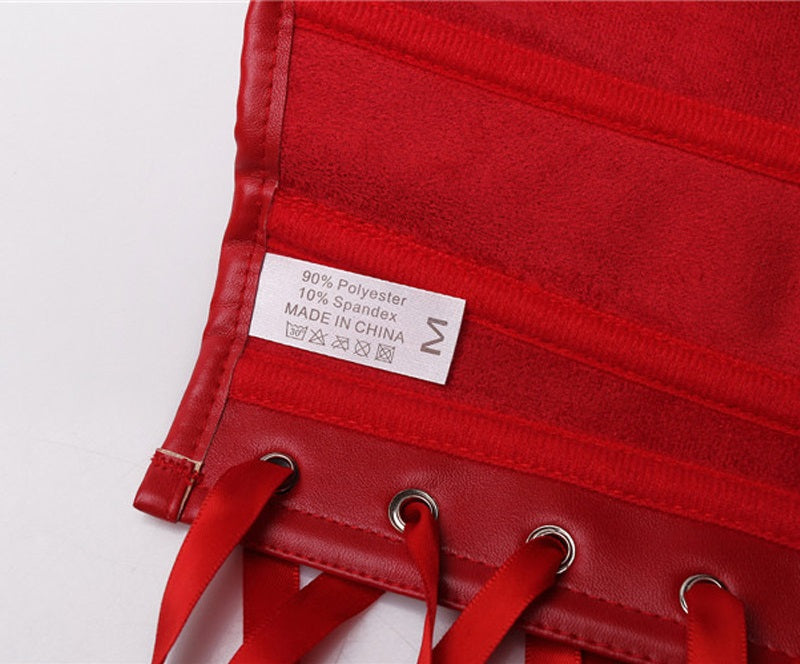 Close-up of fabric care label detailing material composition of a red corset, featuring polyester and spandex blend.