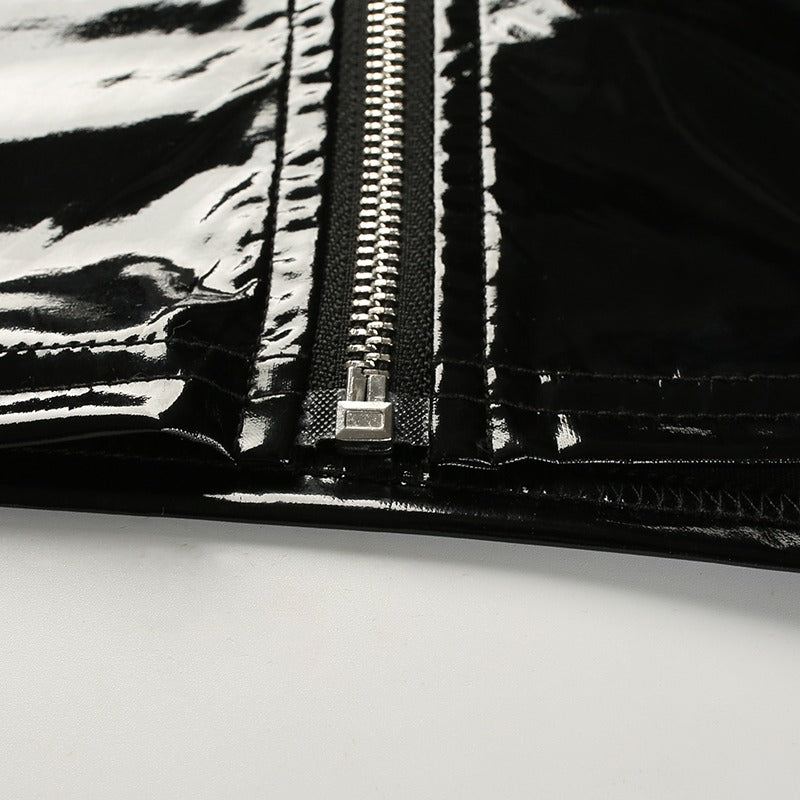 Close-up of shiny black zipper on a sleek synthetic leather crop top, perfect for chic aesthetic outfits.