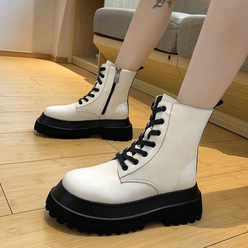 Stylish white and black lace-up boots for women with chunky soles, perfect for casual or dressy occasions.