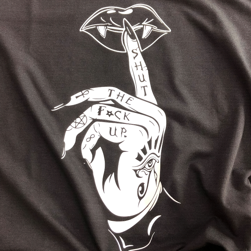 Gothic graphic tee featuring a hand making a shushing gesture with edgy design and bold lettering.