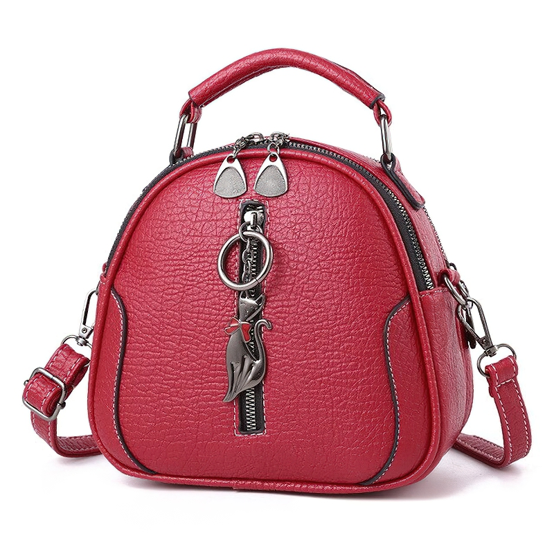 Stylish women’s crossbody small shell bag in red PU leather with cat pendant, perfect vintage accessory.