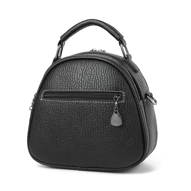 Stylish women's black crossbody shell bag made of PU leather with a charming cat pendant.