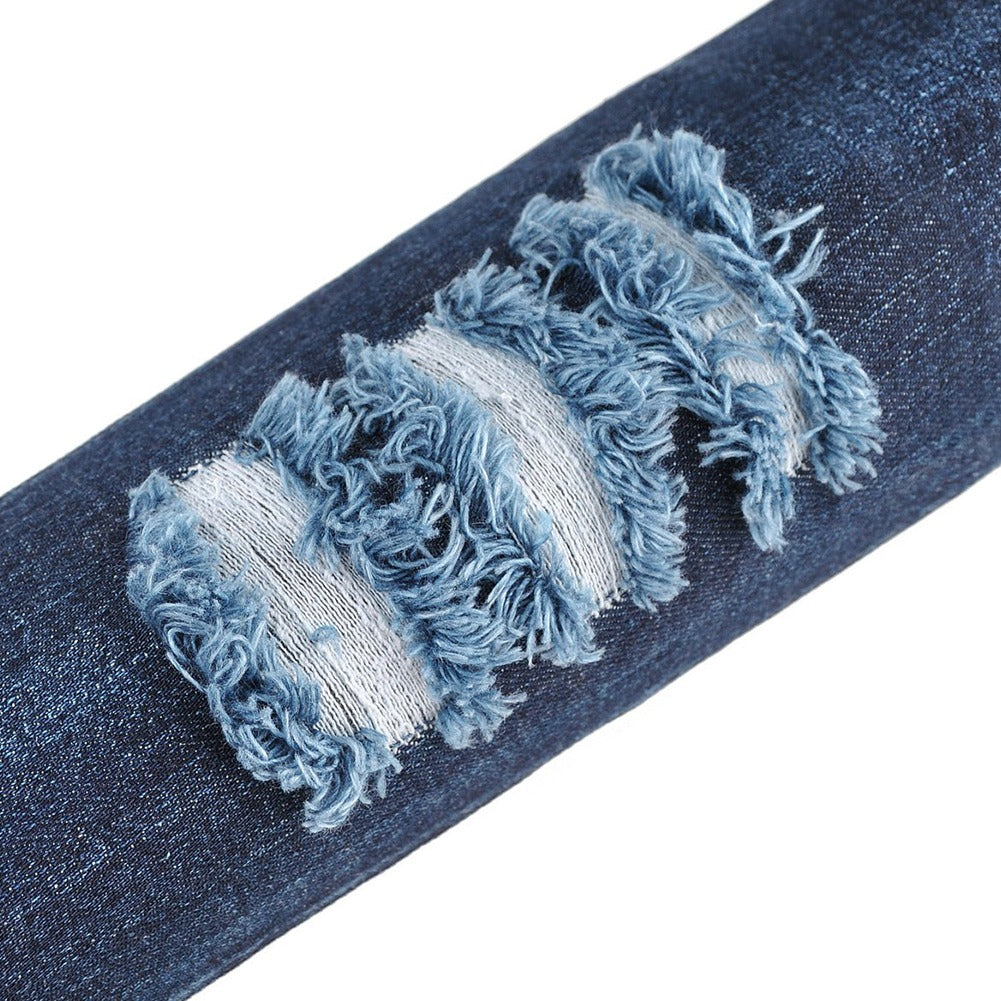 Close-up of distressed denim fabric featuring frayed details for stylish over-the-knee boots.