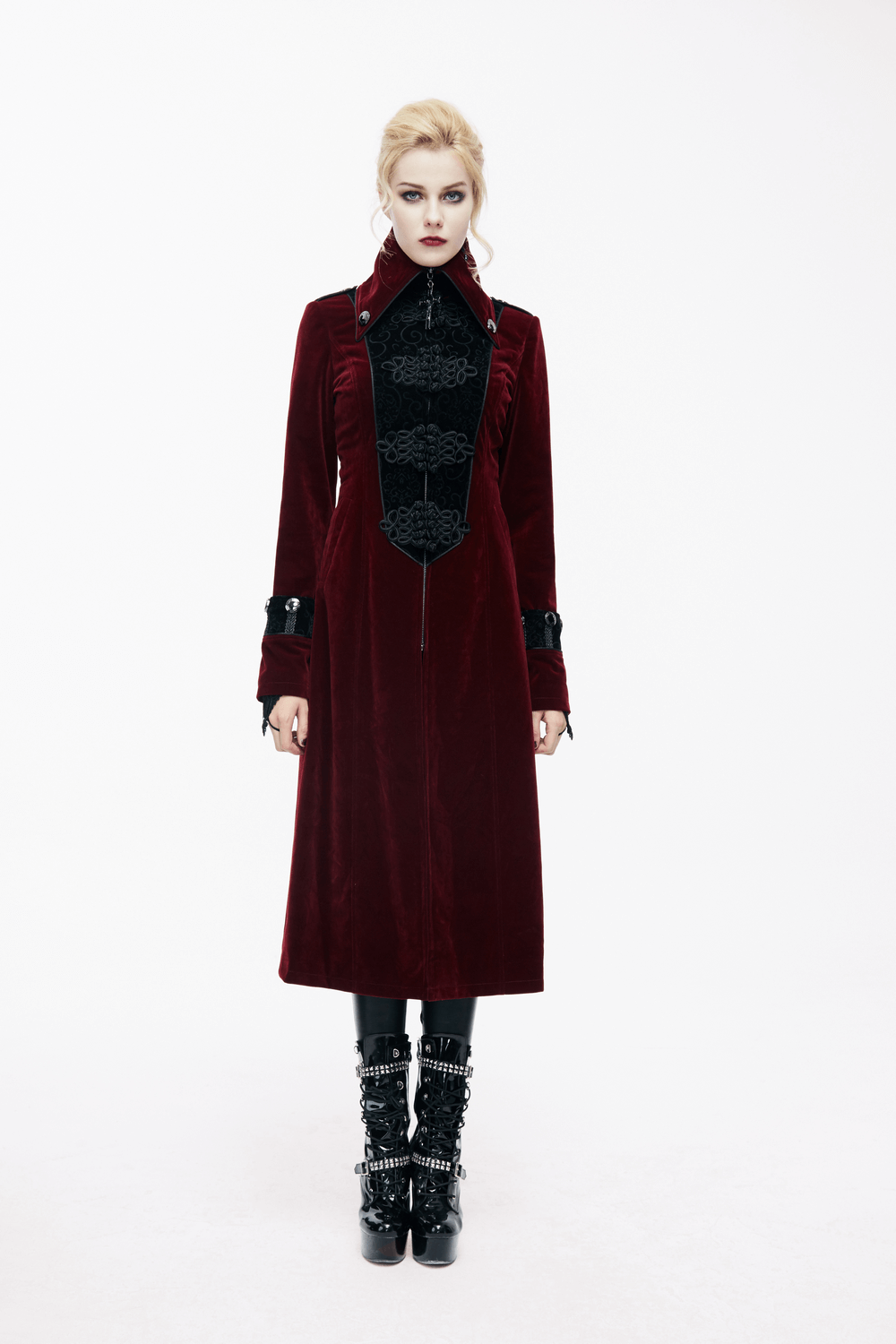 Women in a gothic style long red coat with high collar and lace inserts, showcasing alternative fashion elegance.