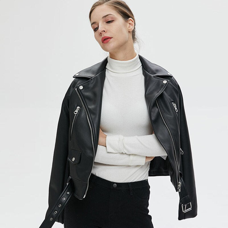 Stylish woman wearing a women's faux leather biker jacket with zippers and a standing collar, perfect for rock outfits.