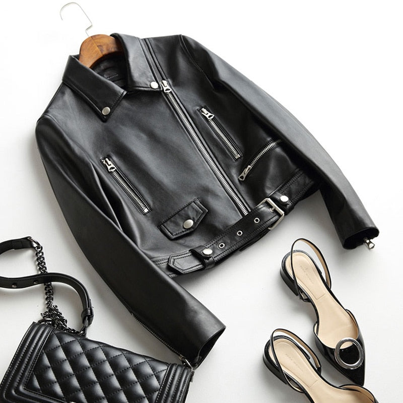 Women’s faux leather biker jacket with zippers, adjustable belt, and classic rock style, perfect for edgy outfits.