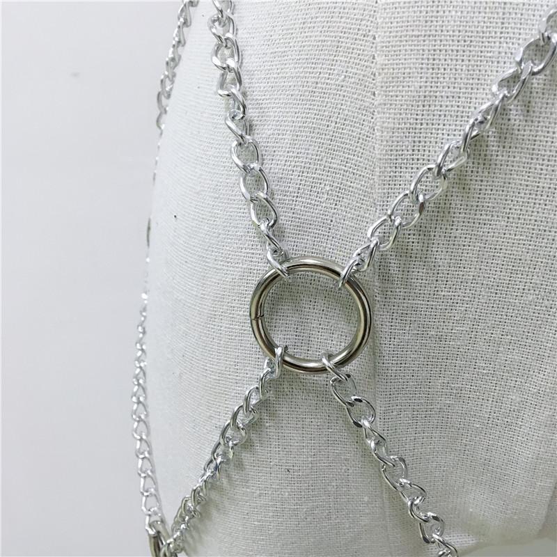 Close-up of women faux leather body harness with silver chains and rings, showcasing rock star fashion style.