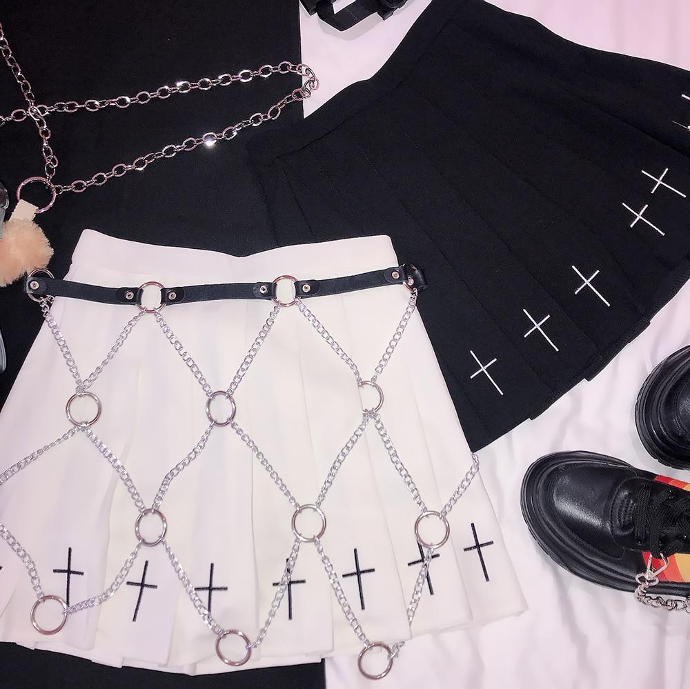 Stylish black and white skirts with faux leather harness chains and cross details, perfect for rock star fashion.