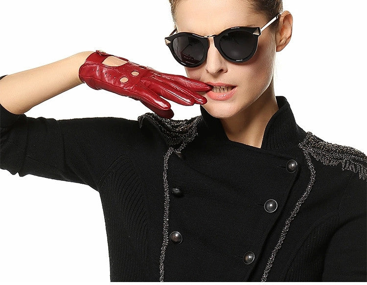 Stylish woman wearing red genuine leather gloves and chic sunglasses, showcasing alternative fashion for spring/autumn.