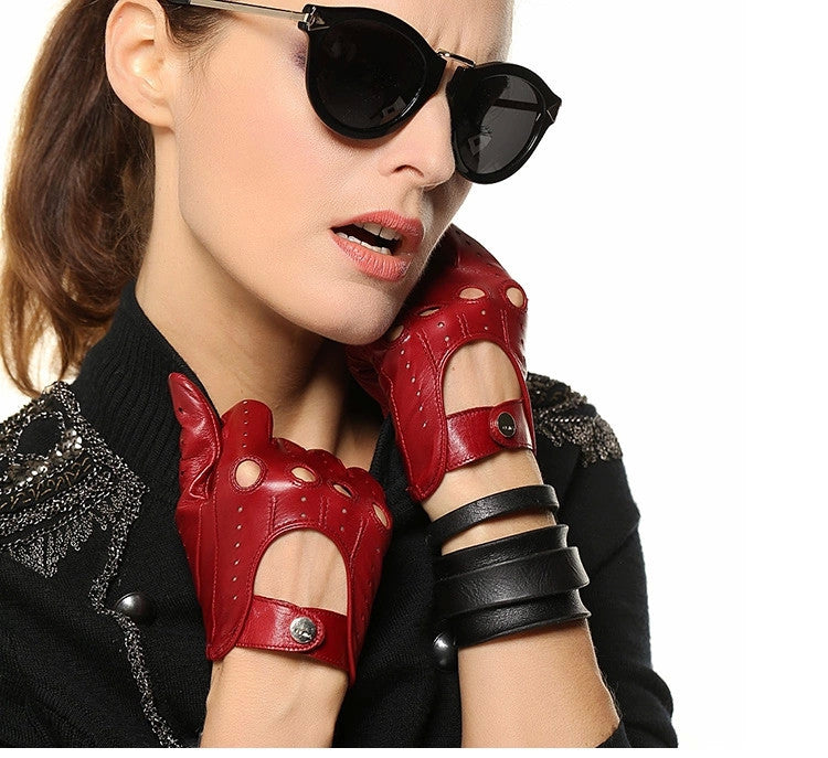 Stylish woman wearing red genuine leather gloves and sunglasses, showcasing alternative fashion and rock style.