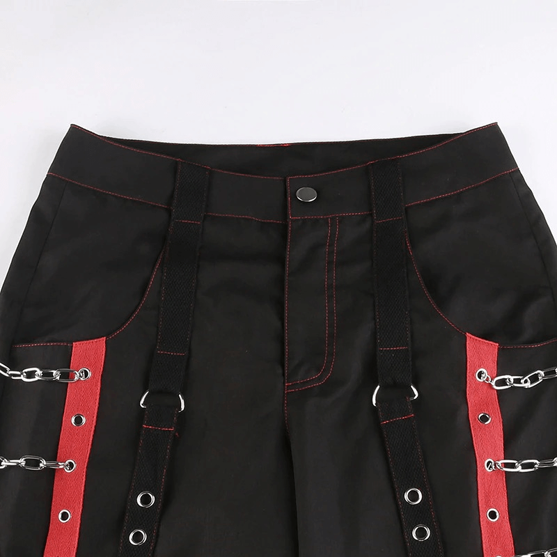 Close-up of women's gothic punk cargo pants featuring red detailing and chain inserts, perfect for casual style.